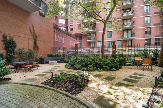 exterior space with outdoor lounge area and fence