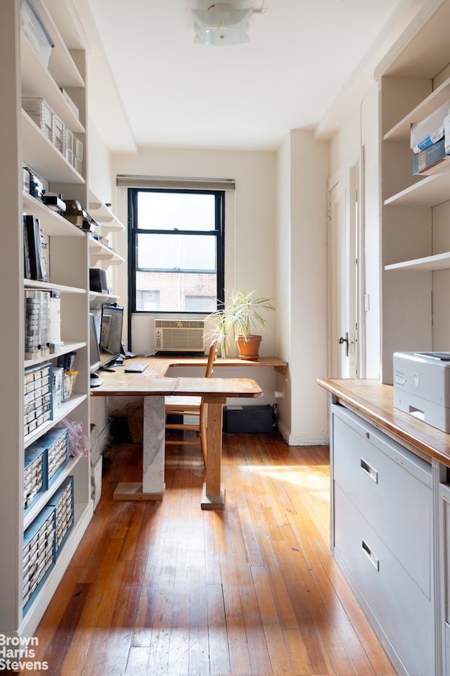 office space with light wood finished floors and cooling unit