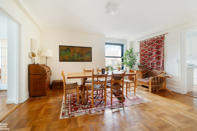 dining area featuring baseboards and ornamental molding