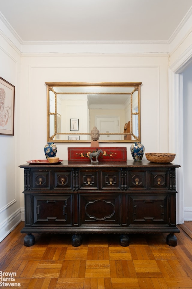 interior details with wood finished floors and ornamental molding