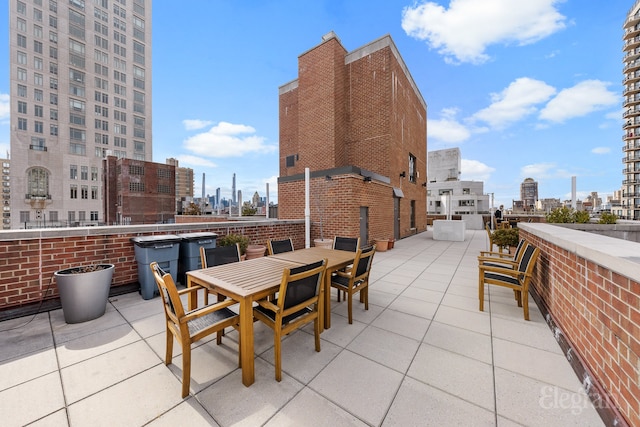 view of patio / terrace featuring a city view and outdoor dining area