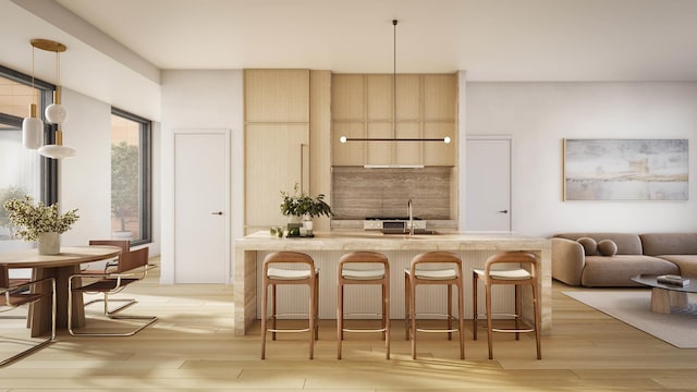 kitchen featuring a breakfast bar, light countertops, and light wood finished floors