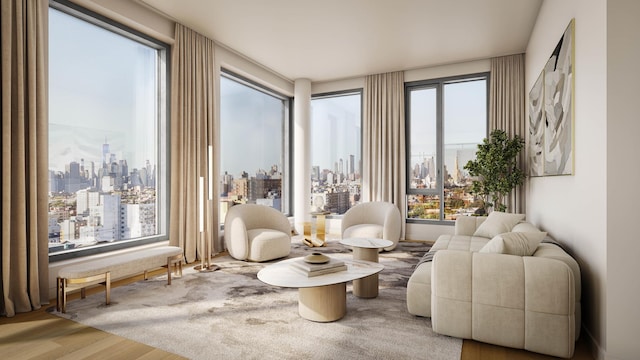 living area with plenty of natural light, a view of city, and wood finished floors