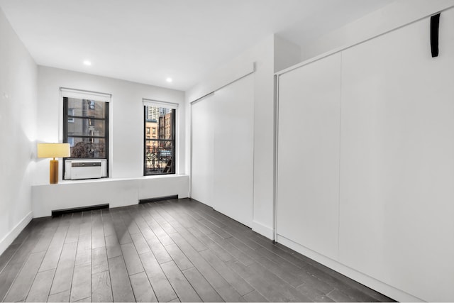 empty room featuring recessed lighting and dark wood-style floors