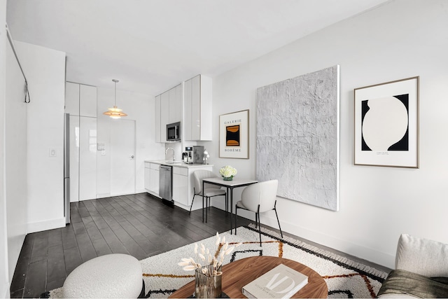 living room with dark wood-type flooring and baseboards