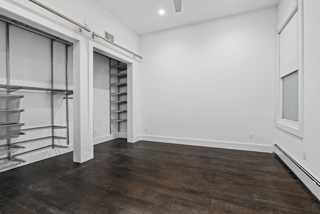 unfurnished bedroom with recessed lighting, baseboards, baseboard heating, and hardwood / wood-style flooring