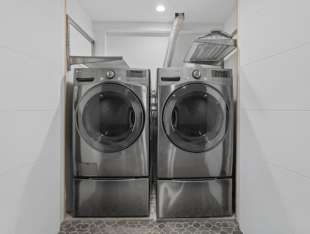 clothes washing area with laundry area and washer and dryer