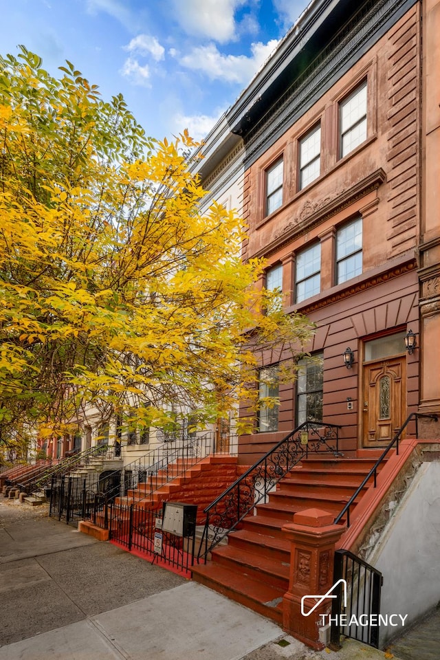 146 W 136th St, New York City, NY 10030 - view of property with a fenced front yard and stairway