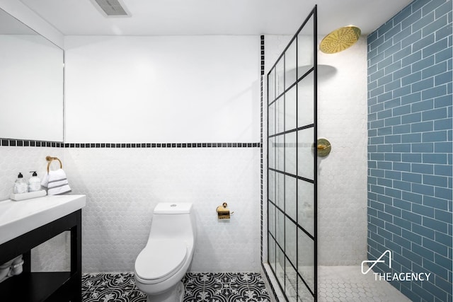 146 W 136th St, New York City, NY 10030 - full bathroom featuring tile walls, tile patterned flooring, a walk in shower, and toilet