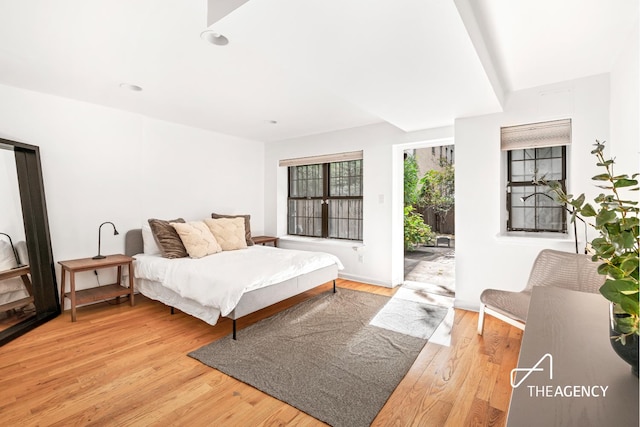 bedroom with light wood-type flooring and access to outside