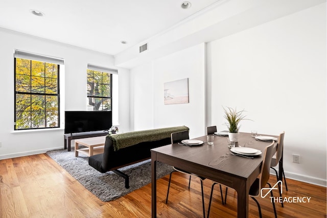 living room with recessed lighting, wood finished floors, visible vents, and baseboards