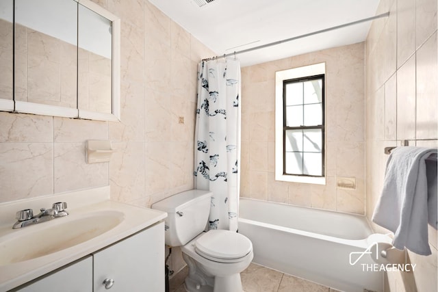 146 W 136th St, New York City, NY 10030 - full bathroom featuring tile walls, toilet, shower / tub combo with curtain, vanity, and tile patterned flooring