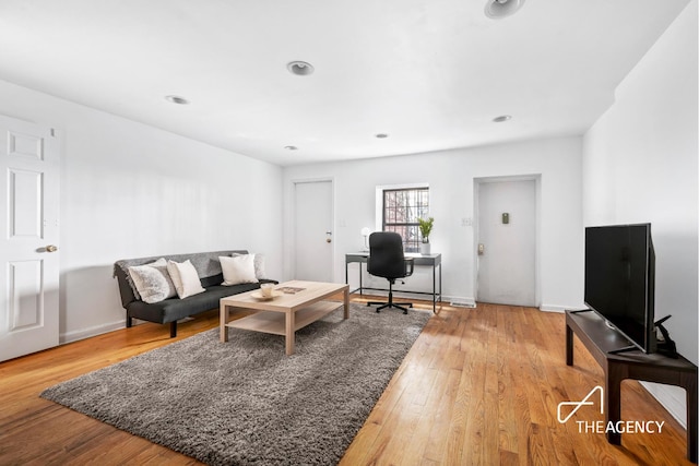 living room with light wood finished floors and recessed lighting