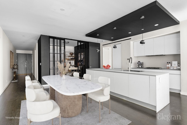 dining area with dark wood-type flooring and baseboards