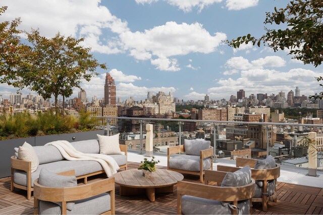 view of patio featuring an outdoor living space, a balcony, and a city view
