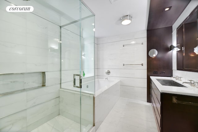 bathroom featuring vanity, a shower stall, a garden tub, and visible vents