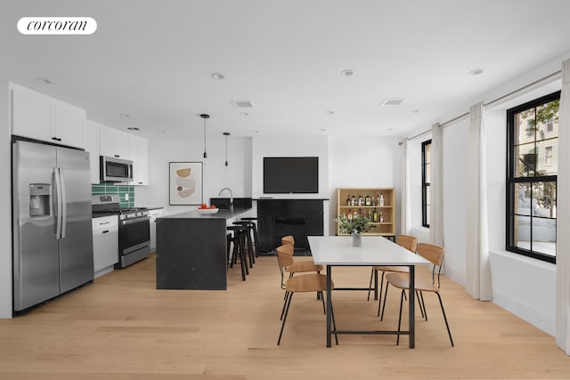 dining room featuring light wood-style flooring and recessed lighting
