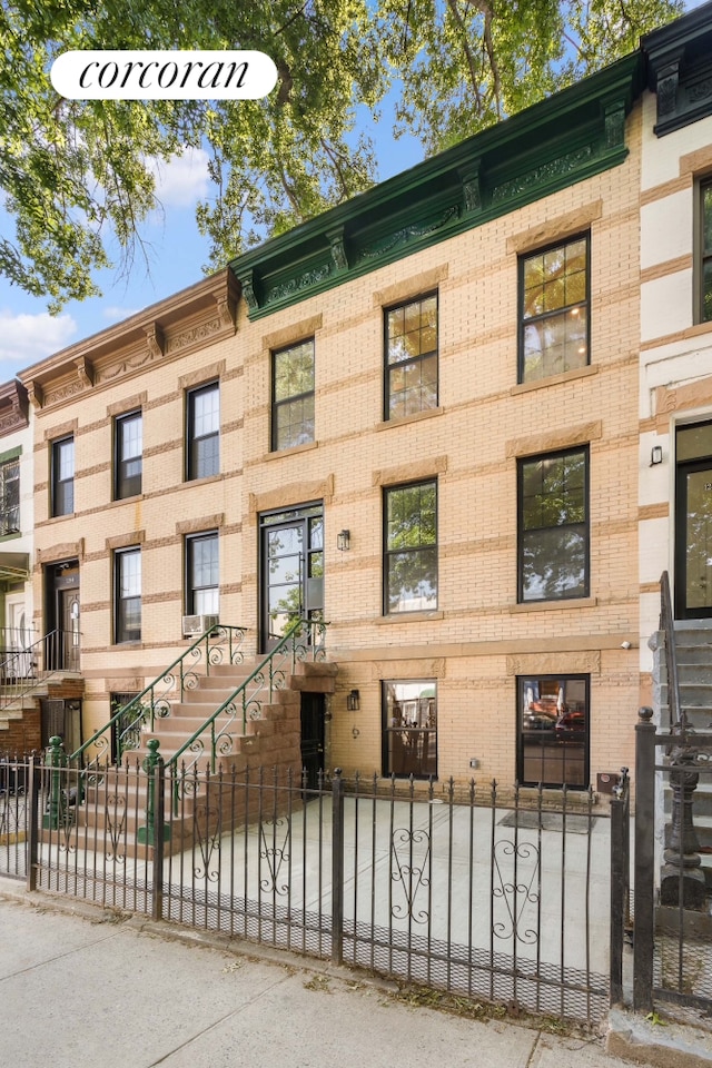 view of apartment building / complex with a fenced front yard