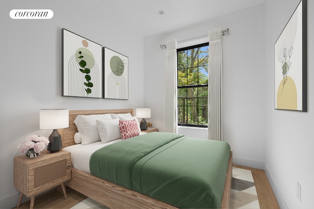 bedroom featuring wood finished floors and baseboards