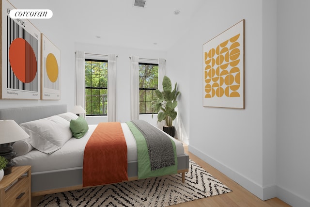 bedroom with wood finished floors and baseboards