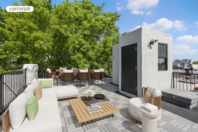 view of patio with a bar, an outdoor living space, and an outdoor structure