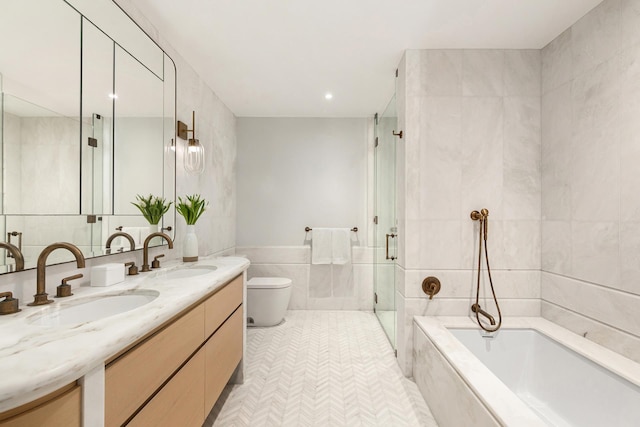 bathroom featuring a sink, toilet, tile walls, and a stall shower