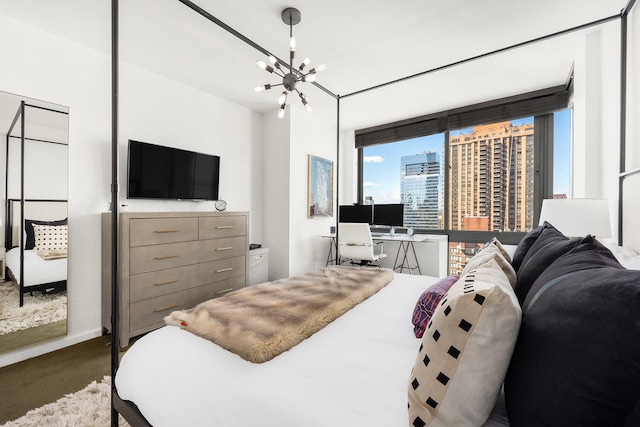 carpeted bedroom with a notable chandelier