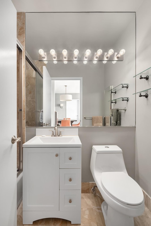 bathroom with a shower with door, marble finish floor, toilet, and vanity