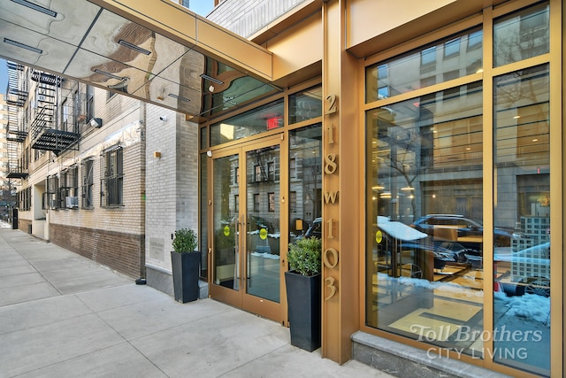 doorway to property featuring brick siding