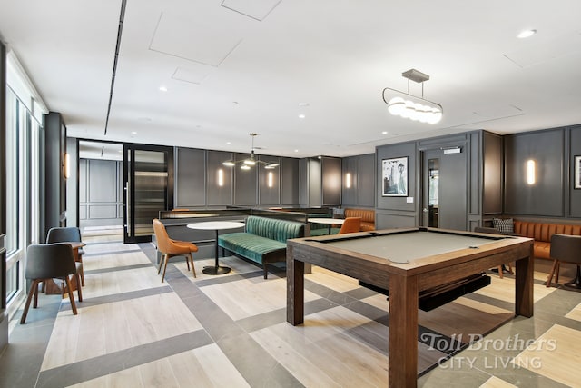 rec room with pool table, a decorative wall, and recessed lighting