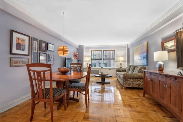 dining space with crown molding and baseboards