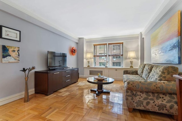 living area featuring baseboards and ornamental molding