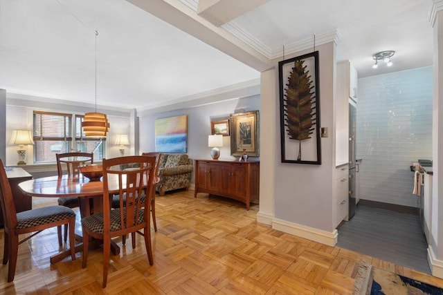 dining space featuring baseboards and ornamental molding