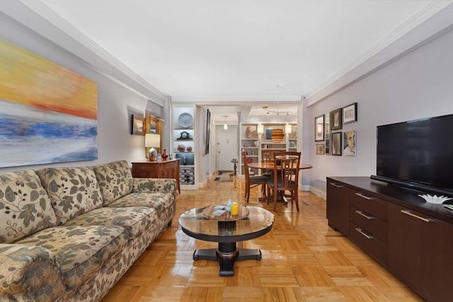 living area featuring baseboards and ornamental molding