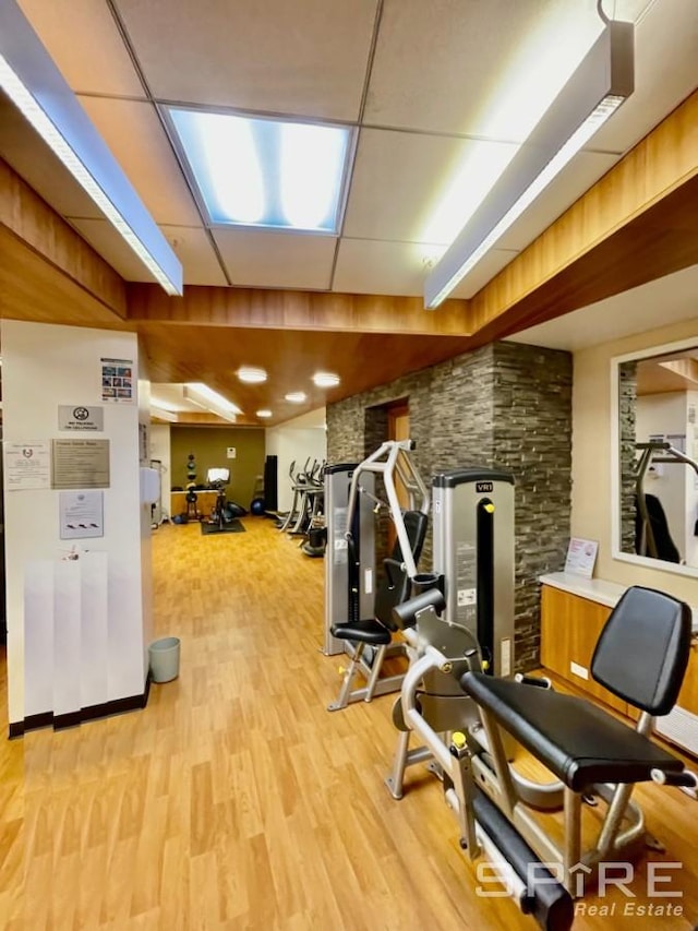 99 John St Unit 1012, New York City, NY 10038 - exercise room with light wood-type flooring and a paneled ceiling