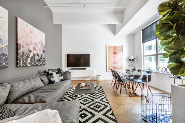 living room featuring beamed ceiling and baseboards