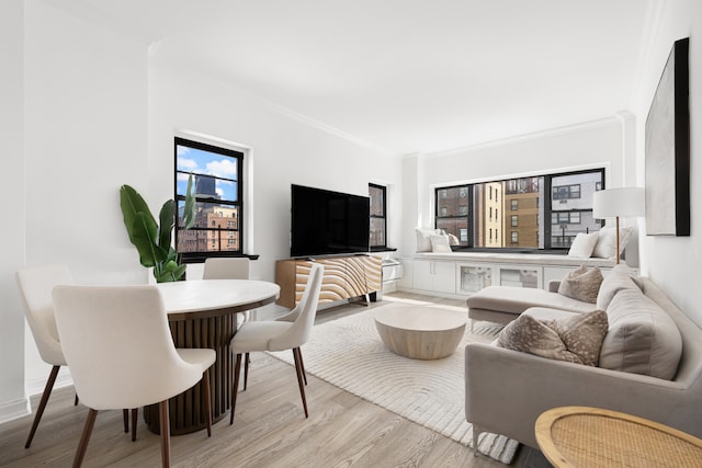 living room with a wealth of natural light, ornamental molding, and wood finished floors