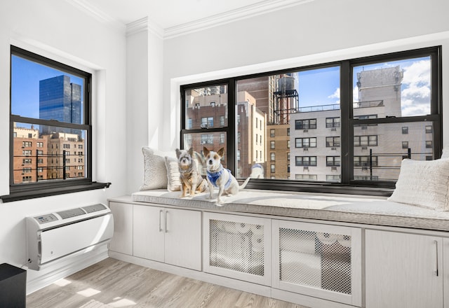 interior space featuring a city view, ornamental molding, heating unit, and wood finished floors