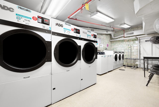 shared laundry area featuring light floors and independent washer and dryer