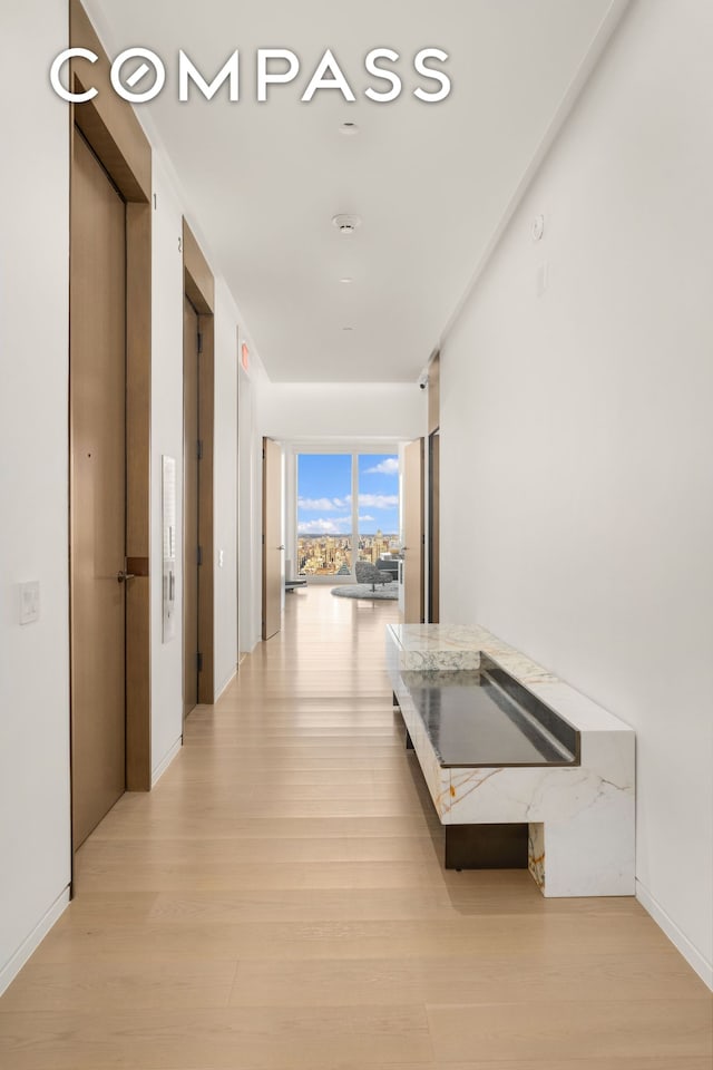 corridor with light wood-style floors