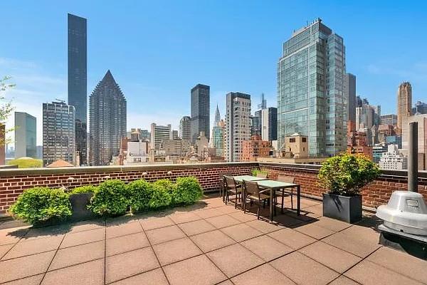 345 E 52nd St Unit 12F, New York City, NY 10022 - view of patio / terrace with a view of skyline, grilling area, and outdoor dining area