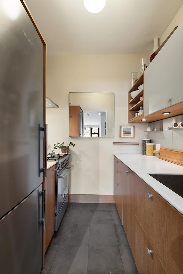 345 E 52nd St Unit 12F, New York City, NY 10022 - kitchen featuring stainless steel appliances, light countertops, dark tile patterned flooring, open shelves, and brown cabinetry