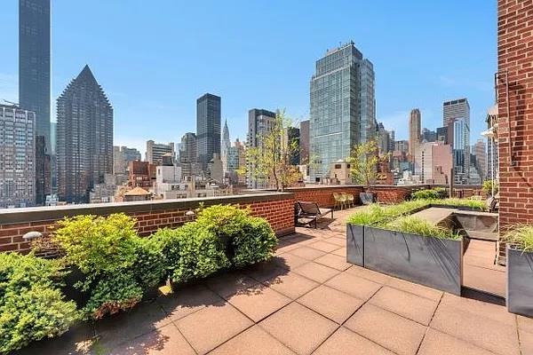 345 E 52nd St Unit 12F, New York City, NY 10022 - view of patio featuring a skyline view