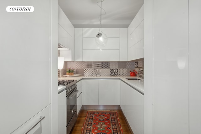 kitchen with white cabinets, refrigerator, modern cabinets, and high end stainless steel range oven