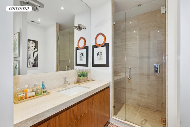 bathroom with a shower stall, vanity, visible vents, and recessed lighting