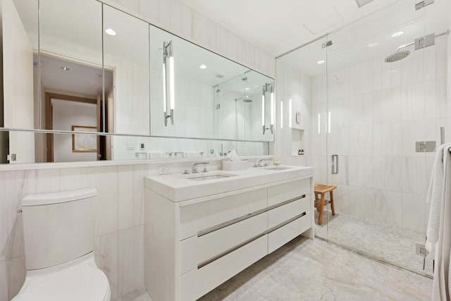 bathroom with a shower stall, toilet, tile walls, and a sink