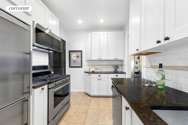 kitchen with recessed lighting, backsplash, appliances with stainless steel finishes, and white cabinets