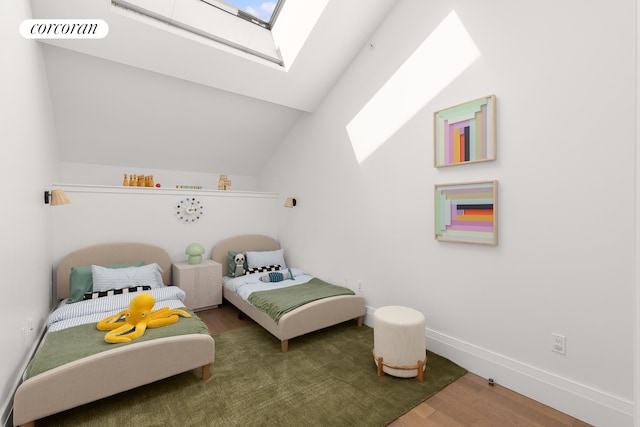 bedroom featuring lofted ceiling with skylight, visible vents, baseboards, and wood finished floors