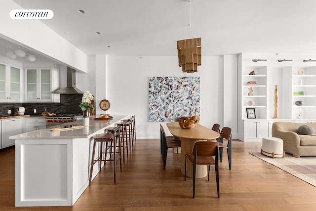 dining space featuring visible vents and wood finished floors