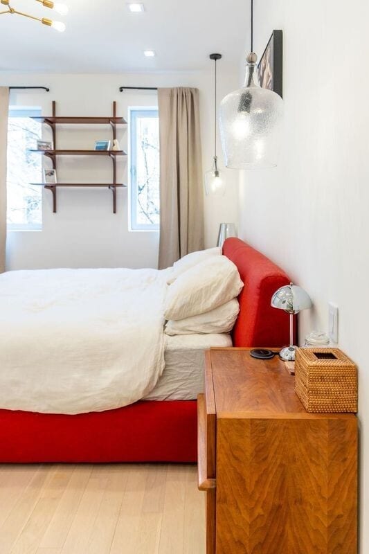 bedroom with multiple windows and wood finished floors